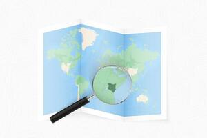 Enlarge Kenya with a magnifying glass on a folded map of the world. vector