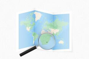 Enlarge Lesotho with a magnifying glass on a folded map of the world. vector