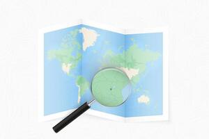 Enlarge Burundi with a magnifying glass on a folded map of the world. vector