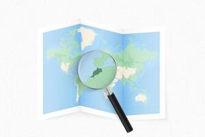 Enlarge Morocco with a magnifying glass on a folded map of the world. vector