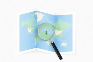 Enlarge Tunisia with a magnifying glass on a folded map of the world. vector