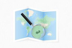 Enlarge Zambia with a magnifying glass on a folded map of the world. vector