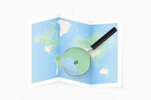 Enlarge Gabon with a magnifying glass on a folded map of the world. vector
