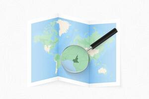 Enlarge Cameroon with a magnifying glass on a folded map of the world. vector