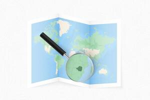 Enlarge Zimbabwe with a magnifying glass on a folded map of the world. vector