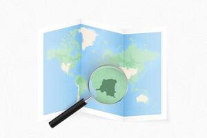 Enlarge DR Congo with a magnifying glass on a folded map of the world. vector