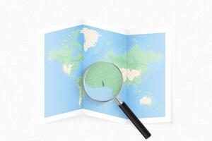 Enlarge Togo with a magnifying glass on a folded map of the world. vector