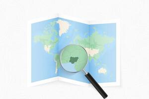 Enlarge Nigeria with a magnifying glass on a folded map of the world. vector
