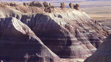 Petrified Forest National Park, Erosion of ancient multi-colored sedimentary rocks from which fossilized sequoias are washed away video