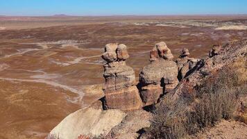 Petrified Forest National Park. Erosion of ancient multi-colored sedimentary rocks from which fossilized sequoias are washed away video