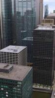 Huge massive building standing close to each other. Densely built area of modern Chicago, Illinois. Top view. Vertical video