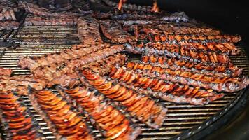 Grilled Ribs on a Large BBQ Grill, Multiple racks of ribs being grilled on a large barbecue grill. video