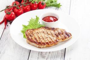 Grilled pork steak with ketchup photo