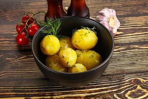 Boiled potato with oil and dill photo