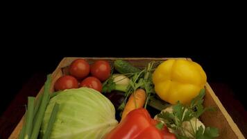 A wooden box is overflowing with a variety of fresh vegetables, showcasing a colorful and diverse selection of produce. video