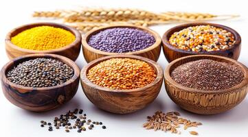 A variety of different colored beans are in wooden bowls. The bowls are arranged in a row, with some bowls containing more beans than others. The beans are of different colors, including yellow photo