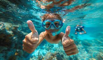 A young boy is swimming in the ocean with his hands up in the air, giving thumbs up photo