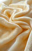 A piece of fabric with a wavy texture and a yellowish color. The fabric appears to be a type of fur or velvet photo