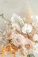 Close-up image of white and light orange orchids and pink roses photo