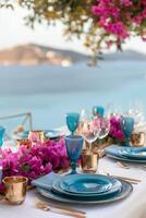 A beautifully decorated outdoor table with bouquets of flowers, luxury tableware and cutlery photo