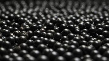 Mesmerizing top view of tightly packed reflective black spheres. photo