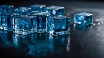 The striking blue ice cubes create a mirror like reflection on a sleek black table offering an eye catching image with ample copy space. photo