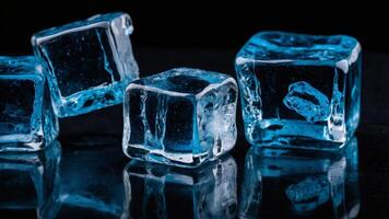 The striking blue ice cubes create a mirror like reflection on a sleek black table offering an eye catching image with ample copy space. photo