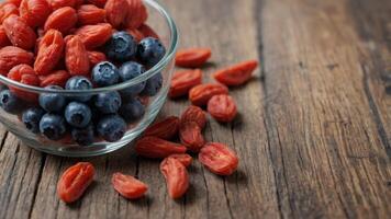 image space copy with table wooden a on arranged berries goji and Blueberries. photo