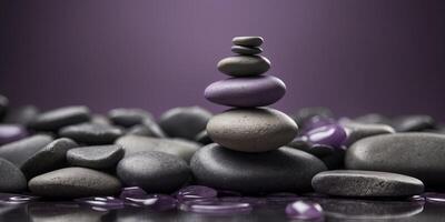 Stack of smooth stones on purple background. photo