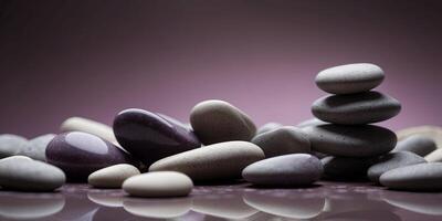 Stack of smooth stones on purple background. photo