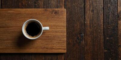 Top view of a cup of coffee displayed on a wooden surface with empty space for additional images. photo