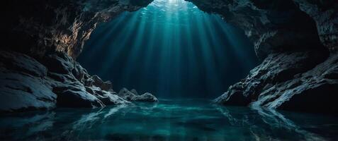 A deep, dark cave with a pool of water at the bottom. photo