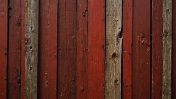 Weathered fence with knots on red panels and closed slots Vertical structure. photo