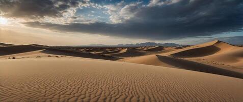 A beautiful landscape of a desert with large sand dunes and a cloudy sky. photo