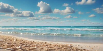 A beach scene with waves approaching the shore and a vibrant blue sky dotted with clouds. photo