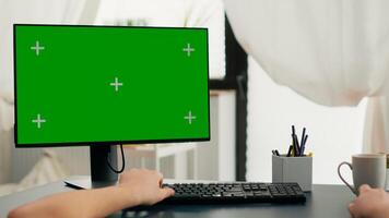 Pov of man hands typing on keyboard for marketing project using computer with mock up green screen chroma key. Caucasian using isolated pc during online business meeting in living room photo