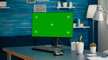 Modern computer with mock up green screen chroma key set up for personal business work. Professional pc with isolated display sitting on office desk in home office with nobody in it photo