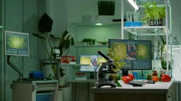 Empty laboratory with nobody in it prepared for genetic test using professional microscope. Biochemistry lab eqquiped with high tech tools for pharmaceutical plant GMO biology medical research test photo
