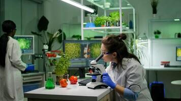 Biologist researcher analyzing biological slide for agriculture expertise using microscope. Chemist scientist examining organic plants in microbiology scientific laboratory photo