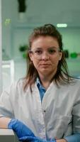 Pov of biologist researcher woman with medical equipment analyzing with biologits team during online videocall meeting while sitting in botanic scientific lab. Specialists researching genetic mutation photo