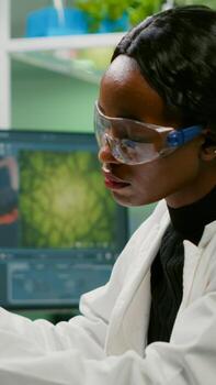 Biotechnology scientist examining botany green leaf using biological microscope researching medical expertise. Chemist analyzing organic agriculture plants in microbiology scientific laboratory photo