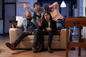Frustrated coworkers losing at games online play, using online game play with vr glasses. Office colleagues feeling sad about lost game at celebration after work hours with beer. photo