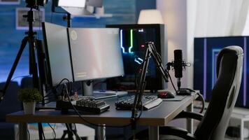 Empty streaming studio with RGB led lights powerful personal computer for gaming online competition. Display with stream chat prepared for virtual tournament, living room with nobody in photo