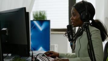 Sad black woman gamer with headphone streaming videogames in gaming home studio losing competition. Professional player talking with other players online for game playing on powerful computer photo