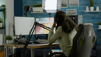 African streamer regrets losing live space shooter game tournament touching temple, chatting with team. Professional gamer streaming online games with new graphics on powerful computer. photo