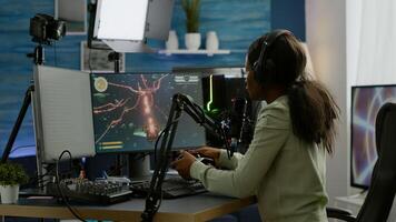 Sad african e sports streaming after losing online competition covering face wearing headphones holding joypad. Pro gamer streaming online games with new graphics on RGB powerful computer. photo