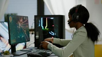 Upsed african woman gamer streaming online videogames and losing playing on RGB powerful computer using wireless controller. Player with headphones celebrating victory in gaming room photo