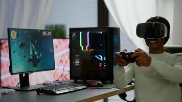 Black videogamer woman winning space shooter game using virtual reality goggles playing games with modern joypad. Professional gamer streaming online videogames with new graphics on powerful computer photo