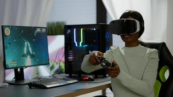 Winner player holding joystick playing videogame in gaming room using virtual reality. Professional pro gamer streaming online videogames with new graphics on powerful computer using modern equipment. photo
