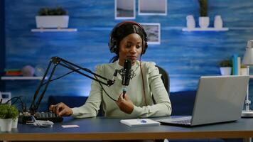 Famous young african woman recording a vlog for subscribers using podcast microphone for vlogging. On-air online production internet broadcast show host streaming live content for social media photo